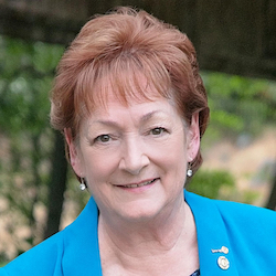 Woman with short red hair smiling at camera